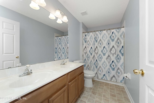 bathroom featuring toilet, walk in shower, a textured ceiling, and vanity