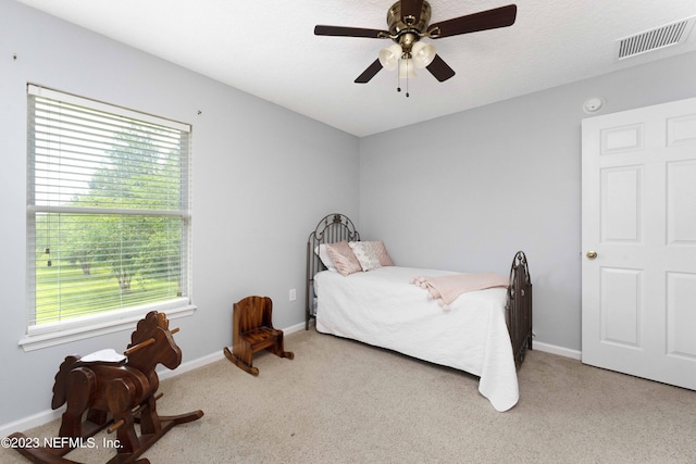 bedroom featuring light colored carpet and ceiling fan