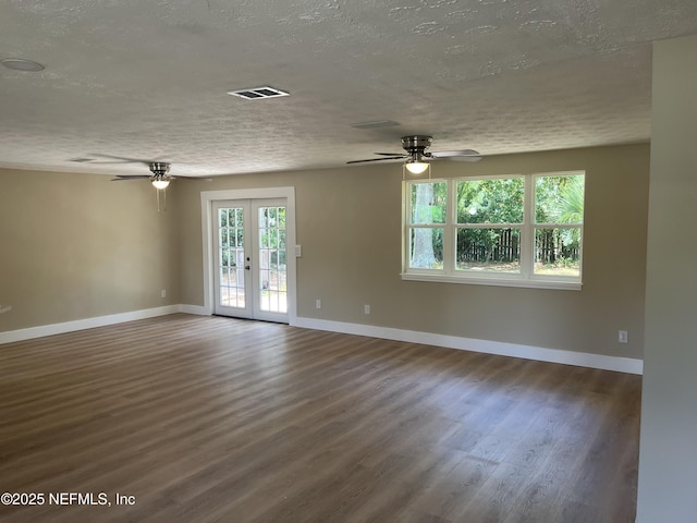 unfurnished room featuring a textured ceiling, ceiling fan, french doors, and dark hardwood / wood-style floors