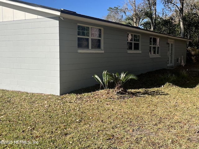 view of property exterior with a lawn