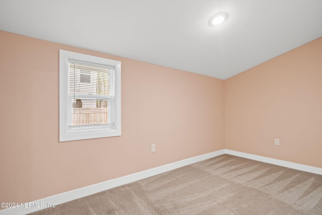 unfurnished room with light carpet