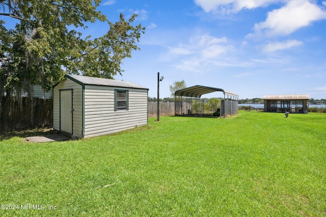 view of yard featuring a shed and a carport