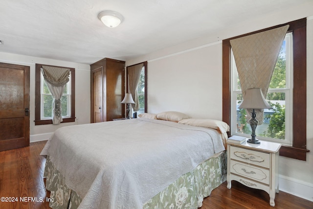 bedroom with dark wood-type flooring