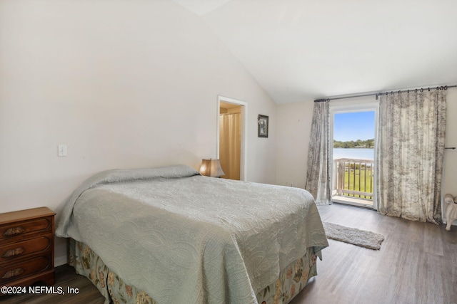 bedroom featuring access to outside, a water view, hardwood / wood-style flooring, and lofted ceiling