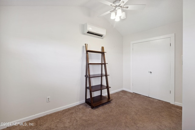 carpeted spare room featuring an AC wall unit, vaulted ceiling, baseboards, and ceiling fan