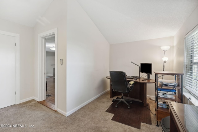 office featuring baseboards, vaulted ceiling, and carpet flooring