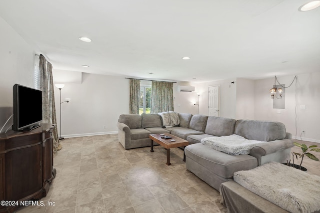 living area with recessed lighting, a wall unit AC, and baseboards