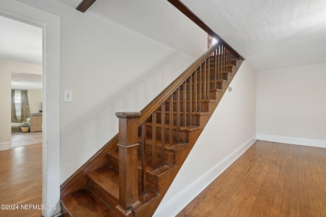 stairway featuring hardwood / wood-style floors