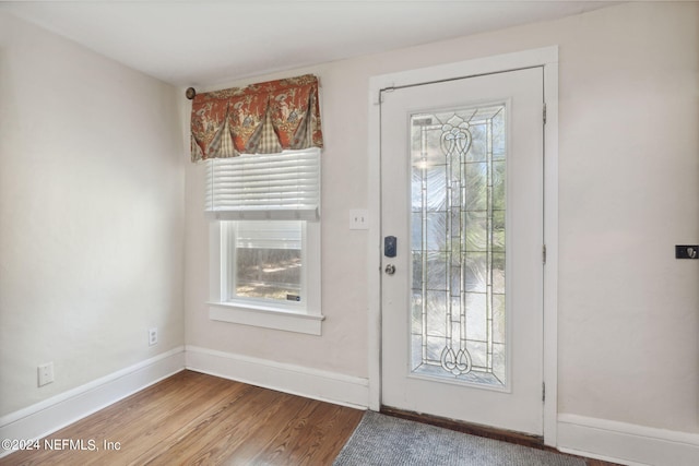 foyer entrance featuring wood finished floors and baseboards