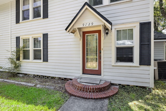 property entrance with central AC unit