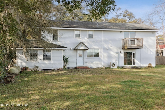 back of property with entry steps, a yard, ac unit, and a balcony