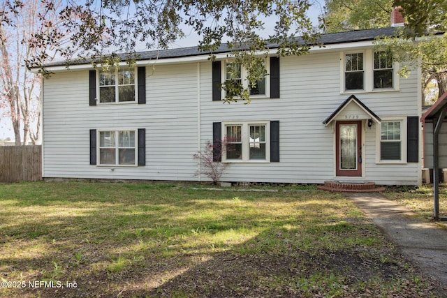 view of front of property with a front yard and fence