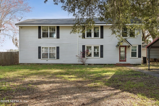 view of front of home featuring central AC, fence, and a front lawn