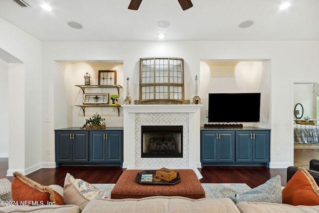 living room with ceiling fan, dark hardwood / wood-style flooring, and a fireplace