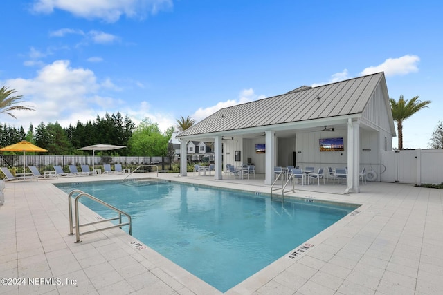 community pool featuring a ceiling fan, a patio area, and fence