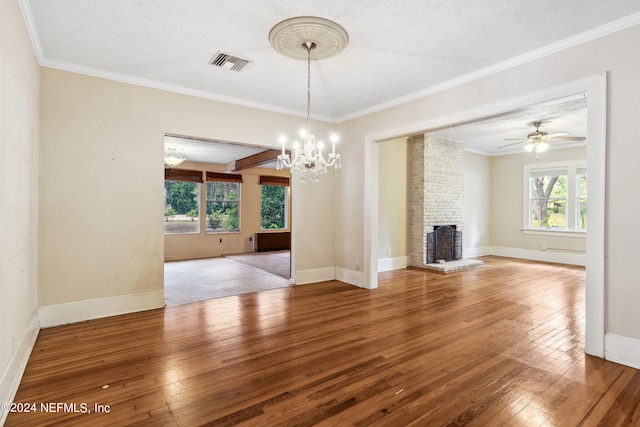 unfurnished living room with ornamental molding, hardwood / wood-style floors, and a fireplace