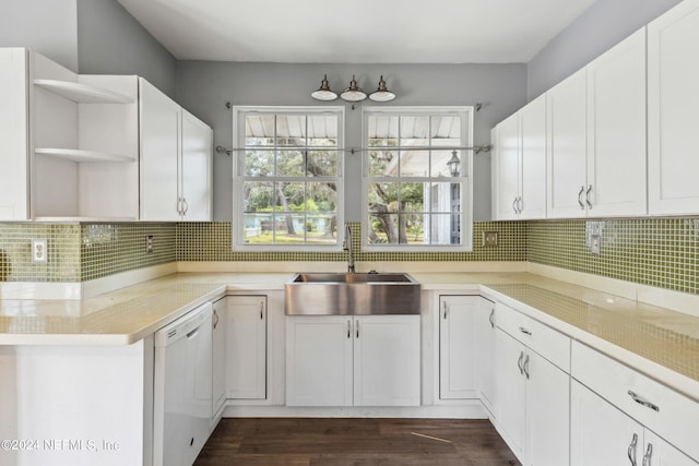 kitchen with sink, dark wood-type flooring, dishwasher, white cabinetry, and decorative backsplash