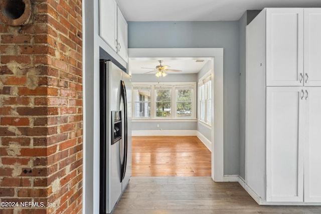 kitchen featuring white cabinetry, ceiling fan, stainless steel fridge with ice dispenser, and light wood-type flooring