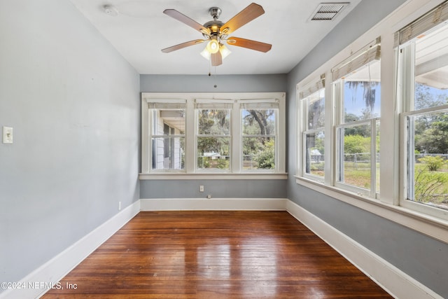 unfurnished sunroom with ceiling fan