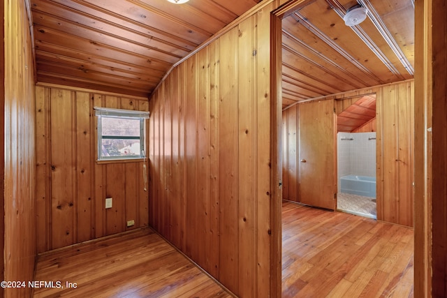 hallway featuring hardwood / wood-style flooring, wooden walls, and wooden ceiling