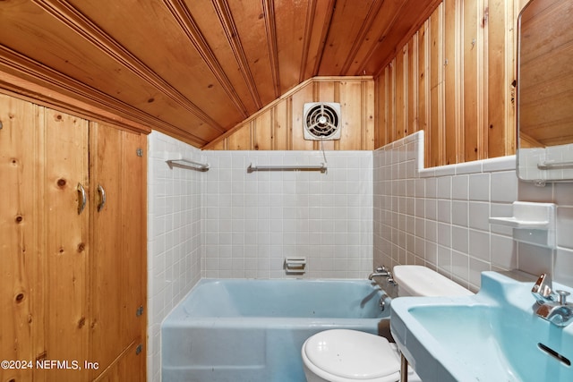 full bathroom with vaulted ceiling, tiled shower / bath, tile walls, toilet, and wooden ceiling