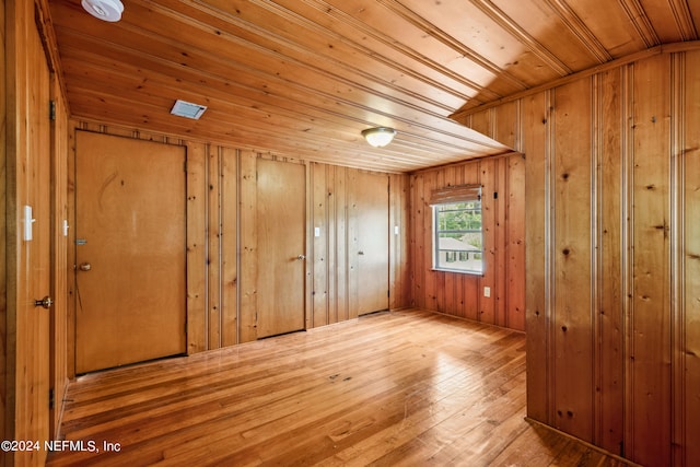 interior space featuring hardwood / wood-style floors, wooden walls, and wooden ceiling