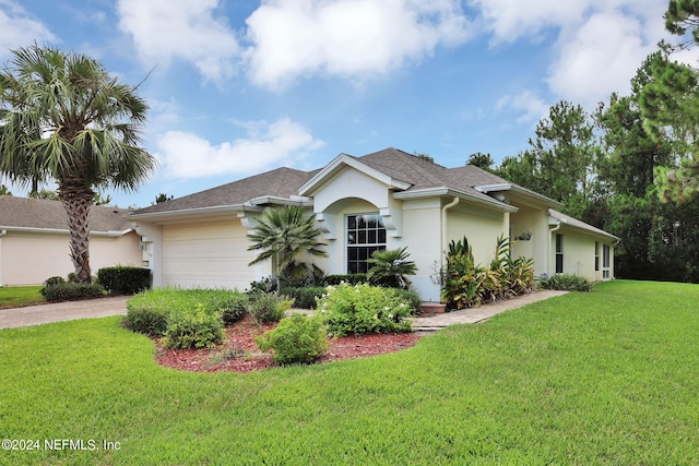 single story home featuring a garage and a front lawn