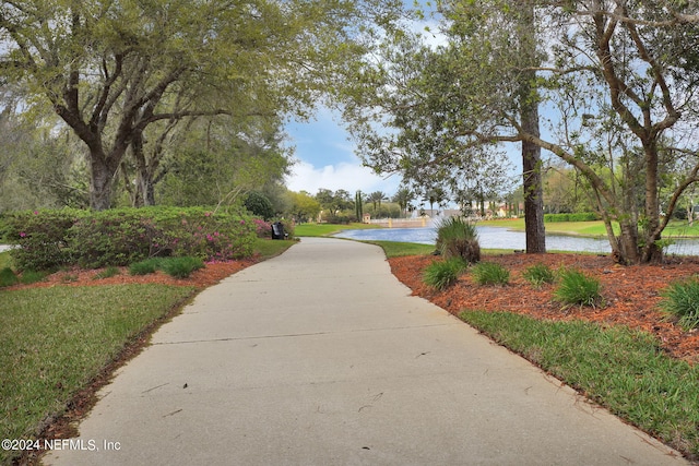 view of community with a water view and a yard