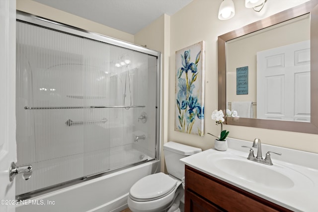 full bathroom featuring bath / shower combo with glass door, toilet, and vanity