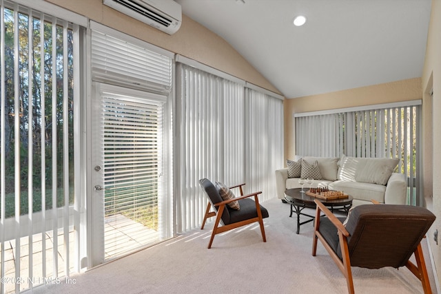 sunroom / solarium featuring plenty of natural light, a wall mounted AC, and vaulted ceiling