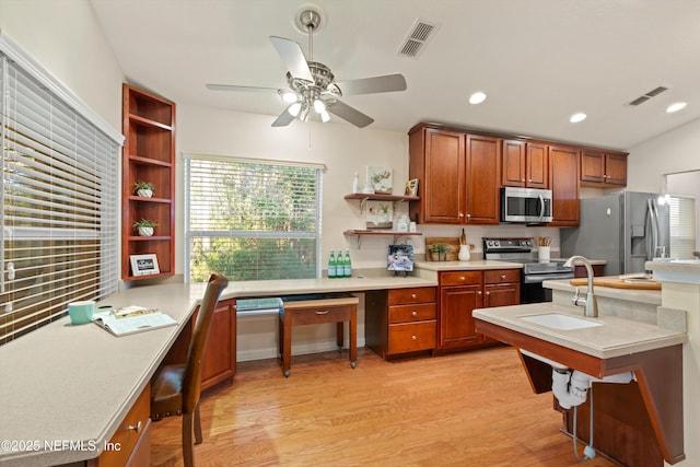 kitchen with ceiling fan, sink, stainless steel appliances, and light wood-type flooring