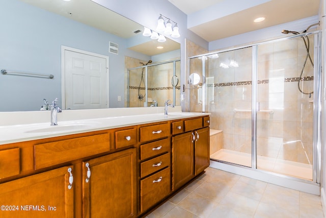 bathroom featuring tile patterned floors, walk in shower, and vanity