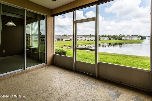 unfurnished sunroom with a water view