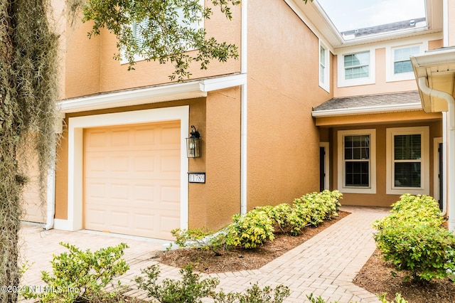 property entrance featuring stucco siding