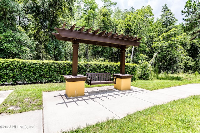 exterior space with a pergola, a lawn, and a patio area