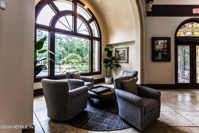 11789 Surfbird Cir Unit 6F, Jacksonville, FL 32256 - foyer entrance with tile patterned flooring, baseboards, and a towering ceiling