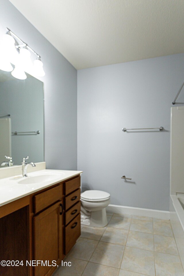 full bathroom with vanity, toilet, tile patterned floors, and bathing tub / shower combination