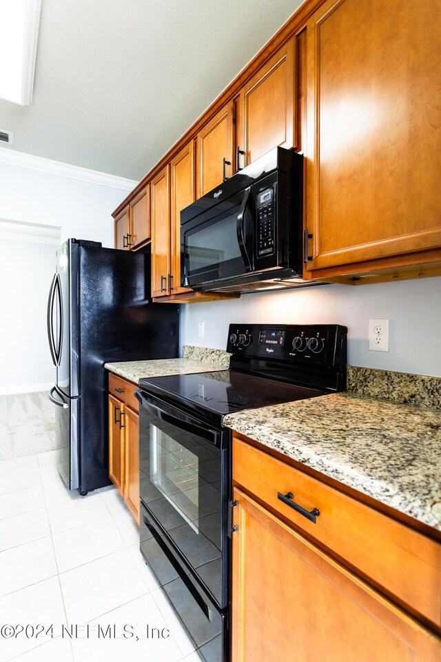 kitchen featuring ornamental molding, black appliances, light stone countertops, and light tile patterned flooring