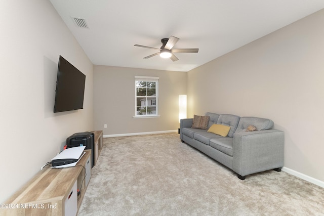 carpeted living room featuring ceiling fan