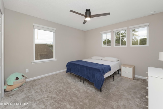 bedroom with ceiling fan and light carpet