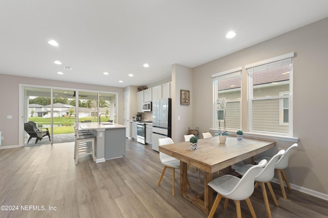 dining room featuring sink and light wood-type flooring