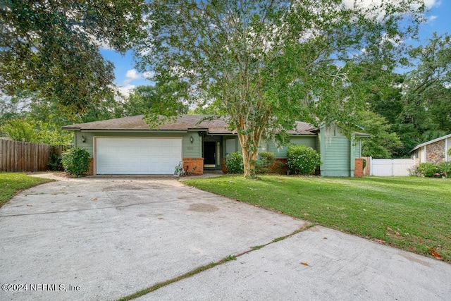 ranch-style home with a garage and a front yard