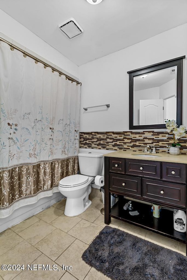 full bathroom featuring shower / bath combination with curtain, backsplash, tile patterned flooring, vanity, and toilet