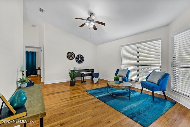 living area with wood-type flooring and ceiling fan