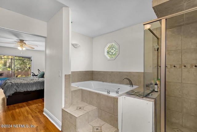 bathroom featuring ceiling fan, wood-type flooring, and separate shower and tub