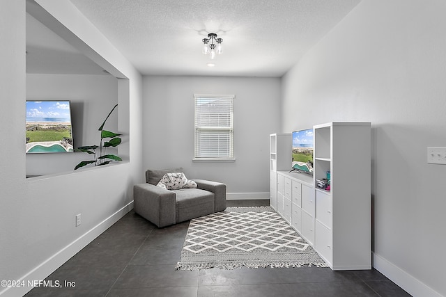 living area featuring a wealth of natural light, a textured ceiling, and baseboards