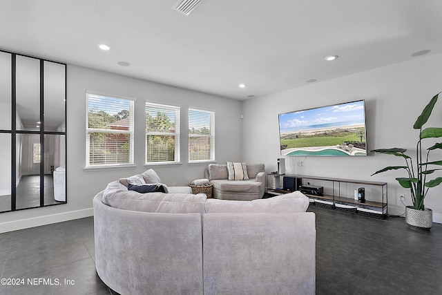 living area with recessed lighting, visible vents, and baseboards