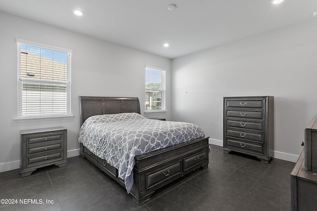 bedroom with baseboards, dark tile patterned flooring, and recessed lighting