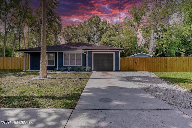 view of front of house with a lawn and a garage