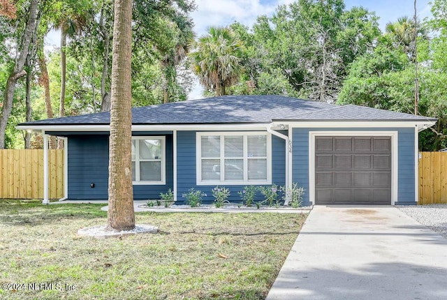 single story home featuring a garage, a front lawn, and a carport